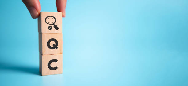 istock Quality control (QC) concept. For business and industry. Standard qulity,guarantee, process, check and approvement. Hand holds wooden cubes with approval process icon standing on abbreviation QC. 1392624289