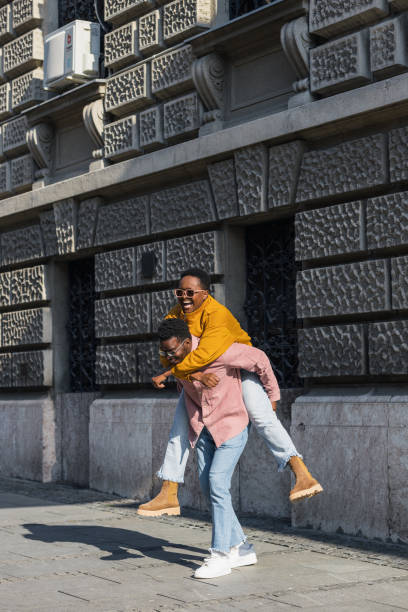 istock Black couple piggyback ride 1392624425