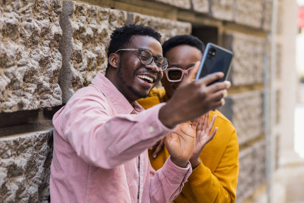 istock Young attractive black couple taking a selfie 1392624601