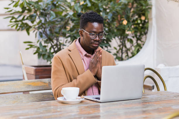 young black businessman praying for good results - prayer call imagens e fotografias de stock