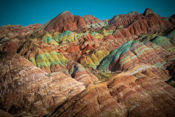 Multicolored geological layers of Zhangye Danxia landform, Gansu, China. Wallpaper, background, brown, red, yellow, green and white colors, rainbow mountains of China