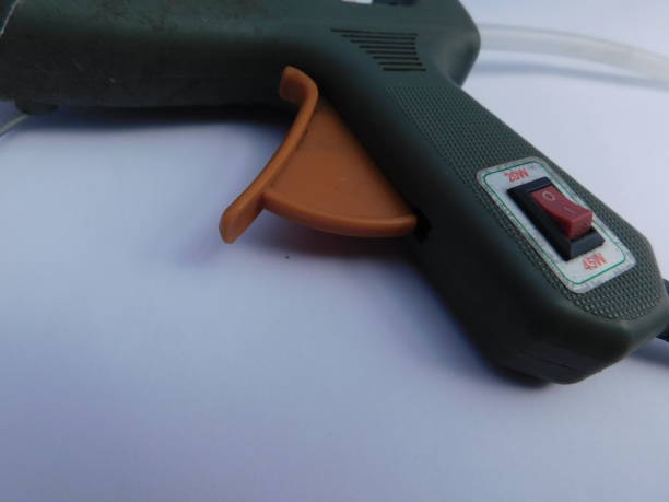 istock green hot glue gun, isolated on a white background 1392631870