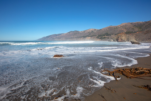 Sea foam on shore at the original Ragged Point beach at Big Sur on the Central Coast of California United States
