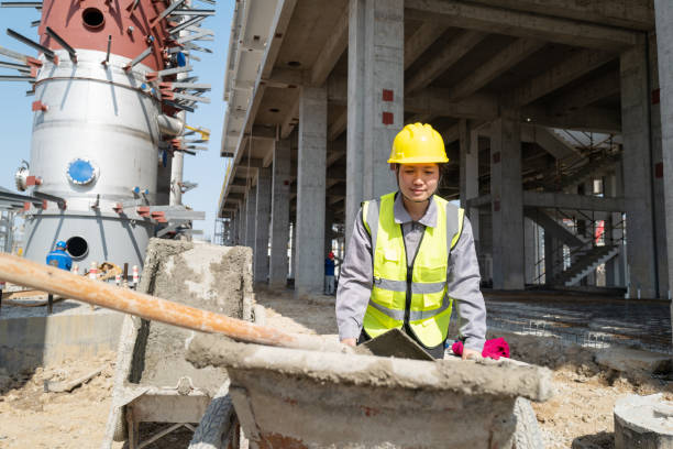 istock Women workers on the construction site use carts to transport cement 1392632945