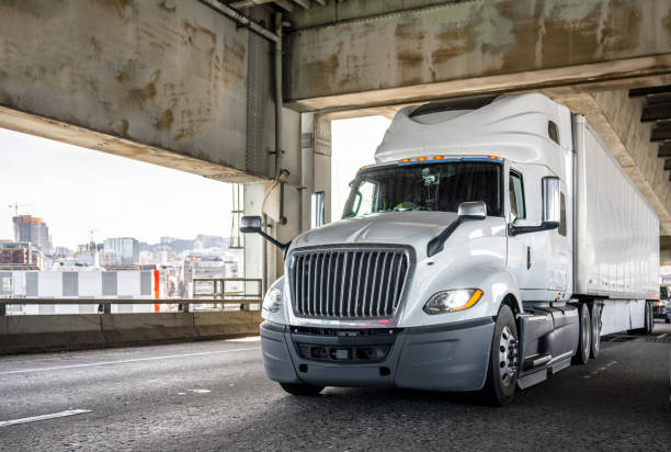 istock Bonnet powerful big rig semi truck with high cab transporting cargo driving on the two level arched Fremont bridge across Willamette river 1392635999
