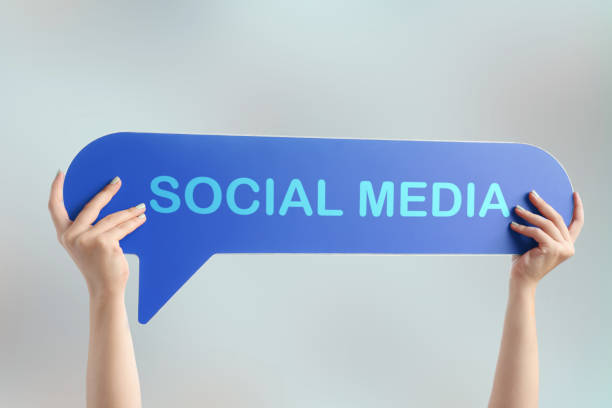 Woman holding placard with social media text