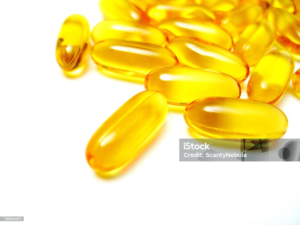 Gel Pills 2 Macro of a bunch of yellow gel pills. Capsule - Medicine Stock Photo