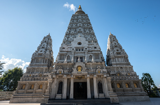 Bayon Temple, Khmer temple related to Buddhism at Angkor in Cambodia. under blue sunny summer sky. 102 MPixel Hasselblad X2D Architecture Shot. Bayon Temple inside the ancient City of Angkor Thom. Bayon (Banyan) Khmer Temple Angkor Thom City close to Angkor Wat Archaeological Area, Siem Reap, Cambodia, Southeast Asia, Asia.