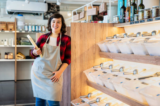 istock Smiling young female zero waste market worker looking at the camera 1392648985