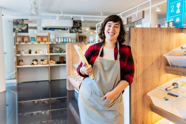 istock Young female employee looking at the camera while standing in zero waste shop 1392648988