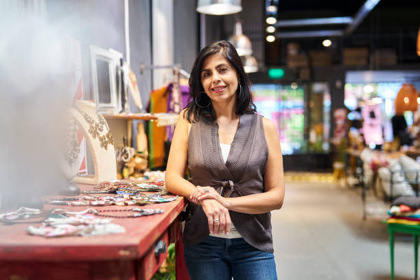 istock Latin american boutique owner leaning on table while looking at the camera 1392649050