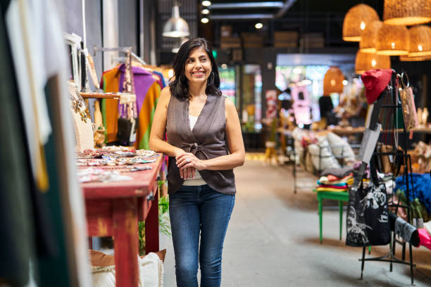 istock Latin american boutique owner standing in store while smiling 1392649058