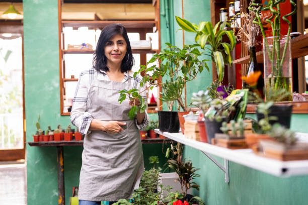istock Latin american plant nursery owner standing outdoors while looking at the camera 1392650583