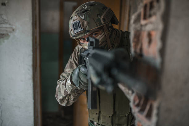istock Special forces soldier armed with rifle in camouflage uniform fighting in conflict zone 1392653764
