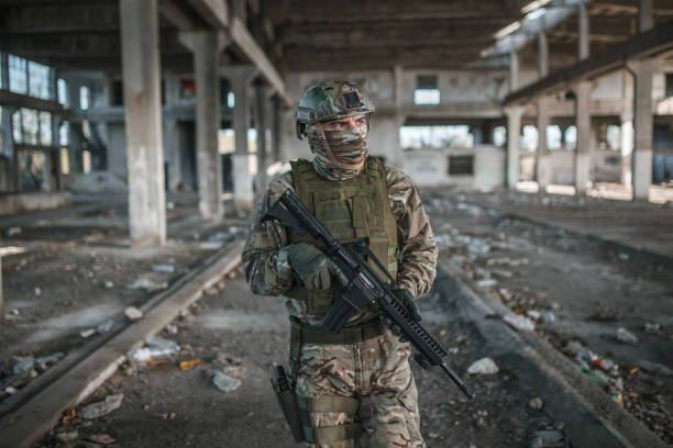 istock Professional soldier in camouflage uniform on patrol in war zone 1392654563