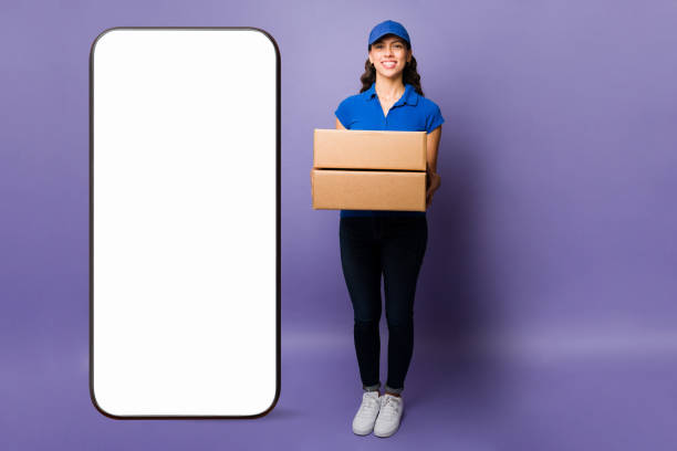 istock Young woman delivering packages with an app 1392657073