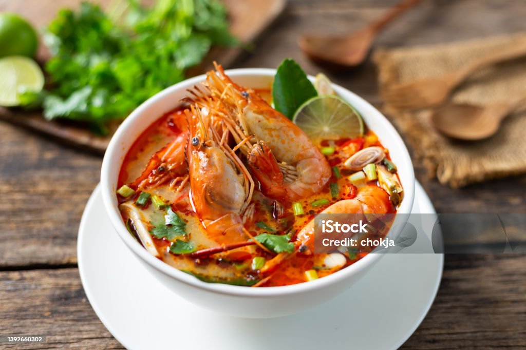 Tom Yam Kung ,Prawn and lemon soup with mushrooms, thai food in wooden bowl top view Tom Yum Soup Stock Photo