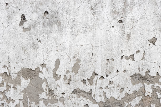 istock Old damaged concrete wall with cracks and grunge textures 1392662701