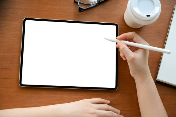 istock Above, Female holding a stylus pen and drawing on digital tablet screen. 1392662777
