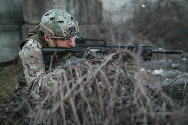 istock Special forces soldier aiming with rifle in war zone 1392663029