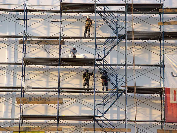 Photo of Picture of four men working on a scaffolding 