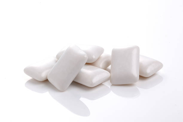 Mint chewing gum in the shape of a pillow on a white background
