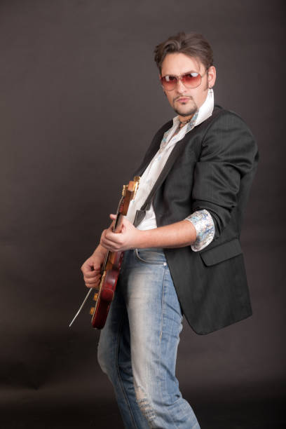 istock man playing electric guitar 1392667124