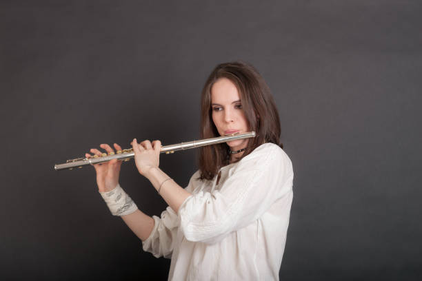 istock woman playing the flute 1392667143