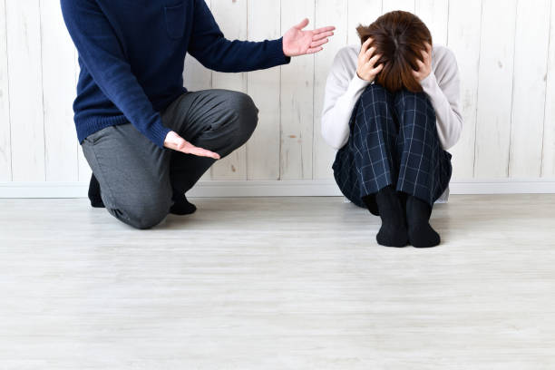 istock Man complaining to woman with head hold 1392673279