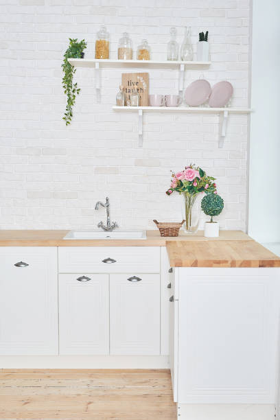 istock White kitchen in interior loft style. Valentine's day kitchen decor. Kitchen utensils and shelves. 1392676508