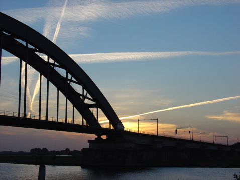 Railway-bridge in Culemborg, The Netherlands by sunset                               