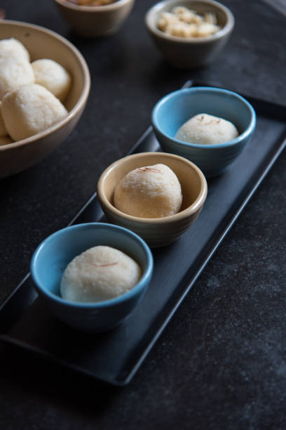Indian dessert item rasgulla or rosogolla in small bowl. Close up. Indian dessert item rasgulla or rosogolla in small bowl. Close up, selective focus. rosogolla stock pictures, royalty-free photos & images