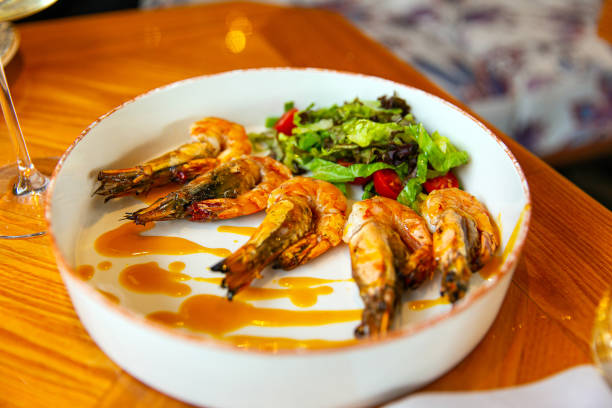 istock Appetizing fried shrimp in mustard sauce with fresh vegetables 1392679744