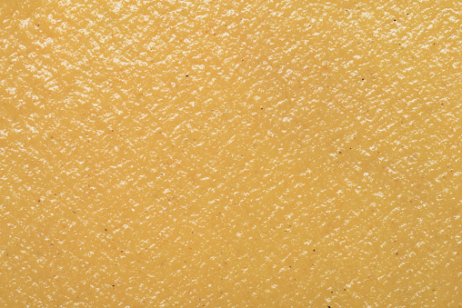 Yellow mustard sauce texture background close up