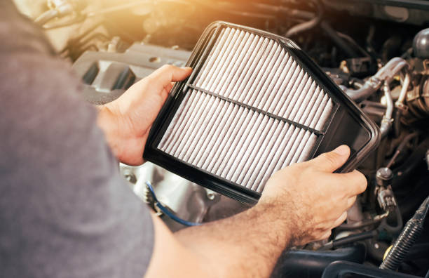 istock A auto mechanic carries a replacement car air filter 1392680994