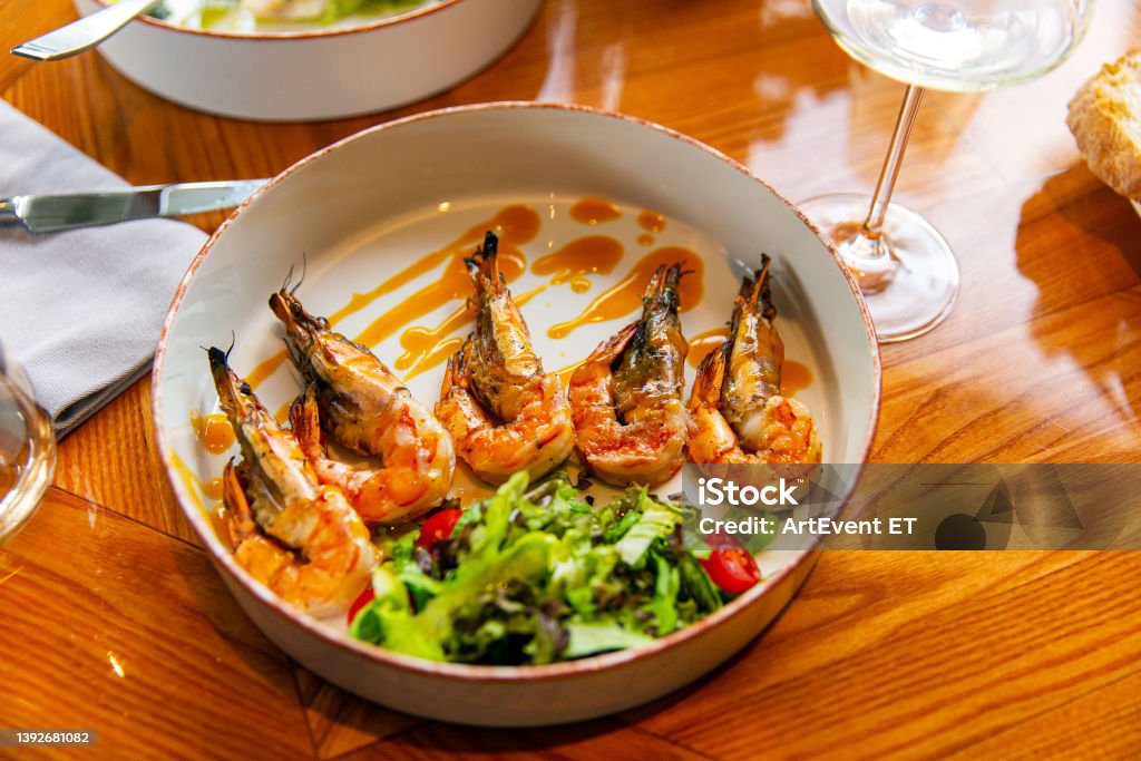 Appetizing fried shrimp in mustard sauce with fresh vegetables Haiti Stock Photo
