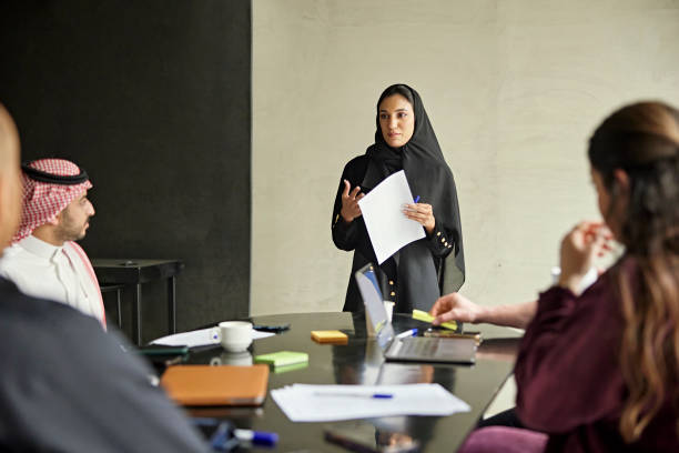 Early 20s Saudi businesswoman presenting ideas to team