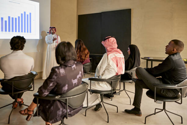 istock Young Riyadh businessman making presentation with bar graph 1392683034