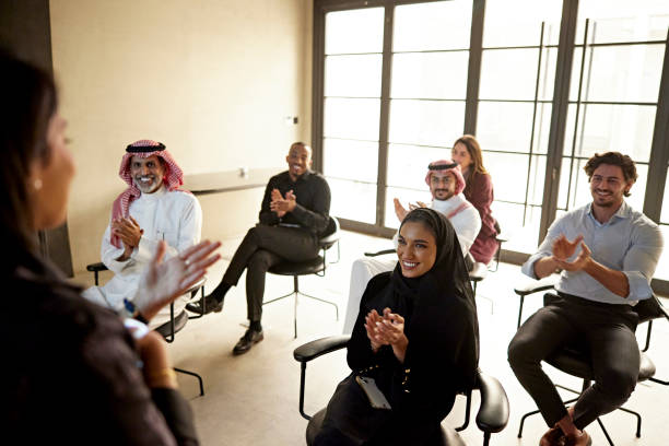 istock Saudi businesspeople applauding presentation 1392683042