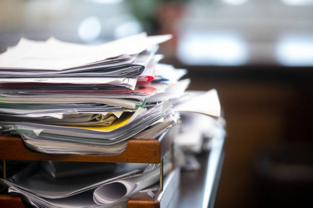 istock Pile of unfinished documents on office desk, Stack of business paper 1392684017
