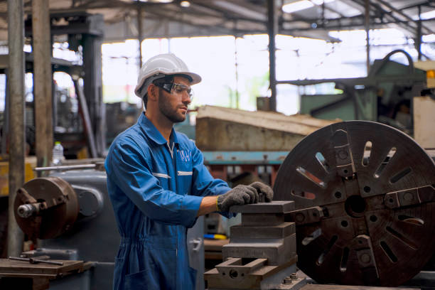 istock Blue collar worker with co worker at factory. 1392685205