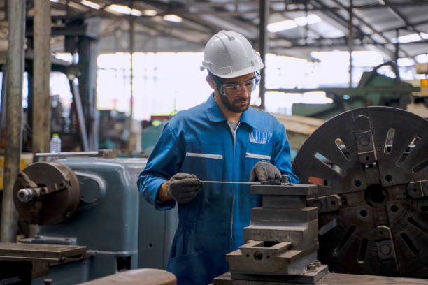 istock Blue collar worker with co worker at factory. 1392685212