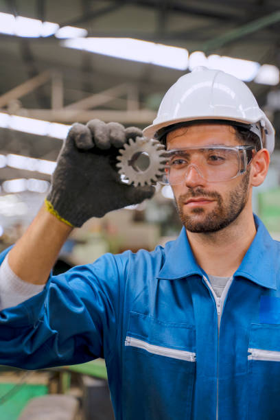 istock Blue collar worker with co worker at factory. 1392685246