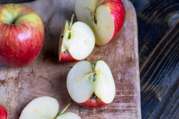 istock cutting old board with pieces of red ripe apple 1392685505