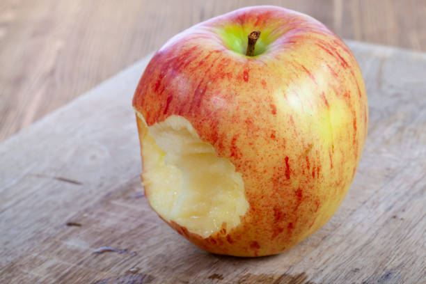 istock red ripe apple on a wooden chopping board 1392685506