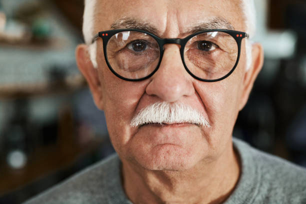 istock Senior man with mustache at home. 1392685715