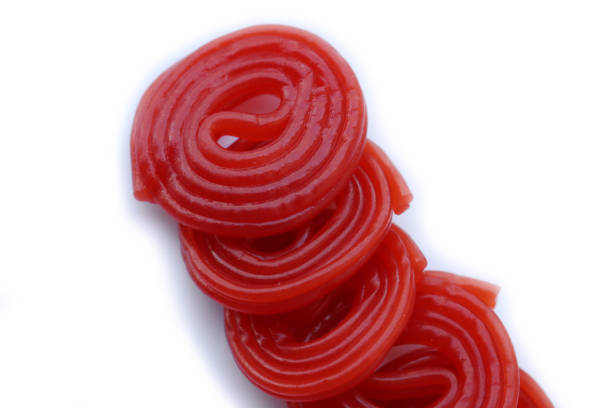 istock Sweet red candies rolled in a spiral  on white 1392686294