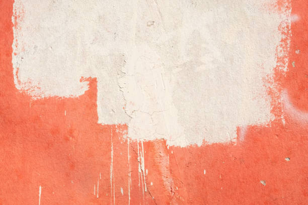 istock White paint on a red weathered wall background 1392688811