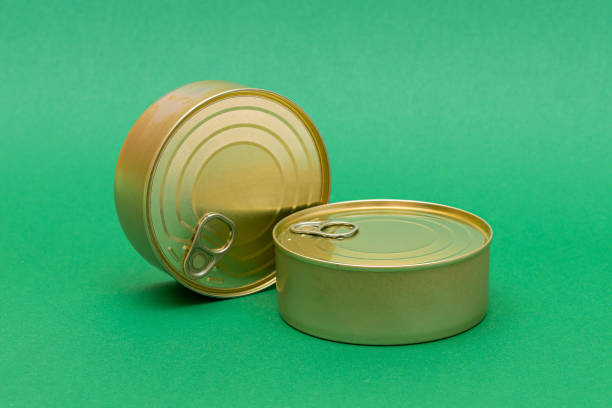istock Unopened Tin Cans with Blank Edges on Green Background 1392690952