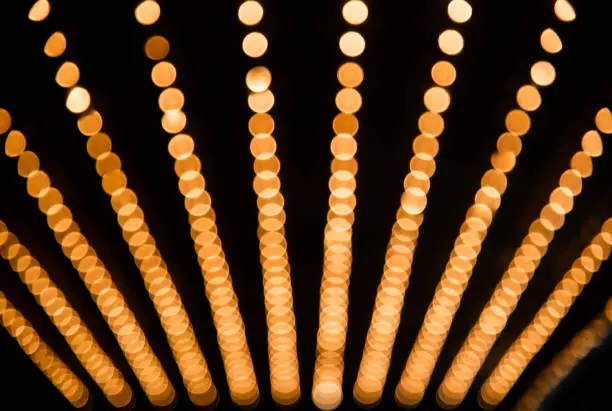 Rows of illuminated globes under the marquee as often used at entrance to theatres and casinos